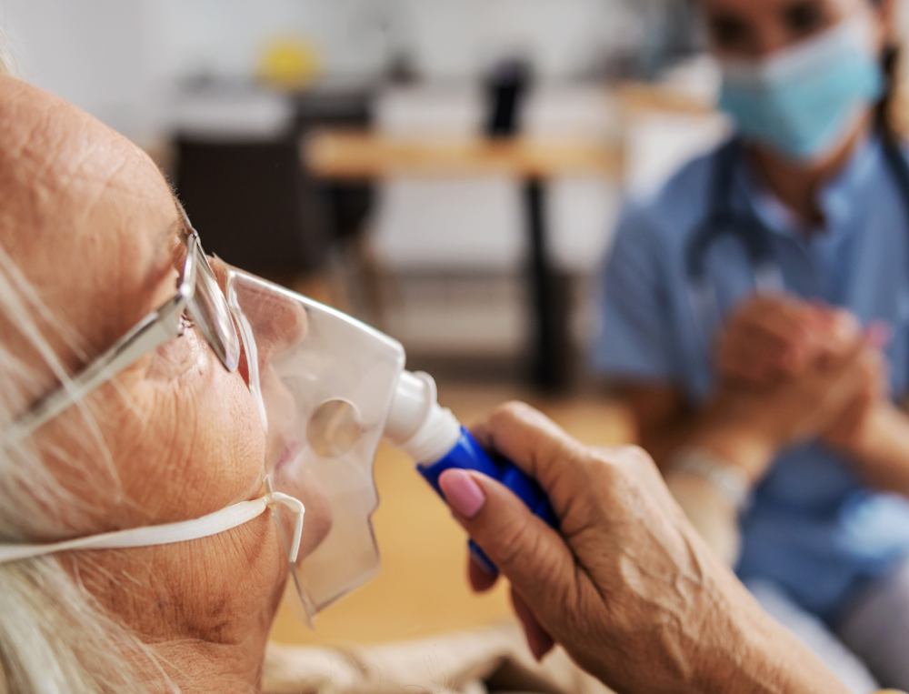 old woman using an inhalator